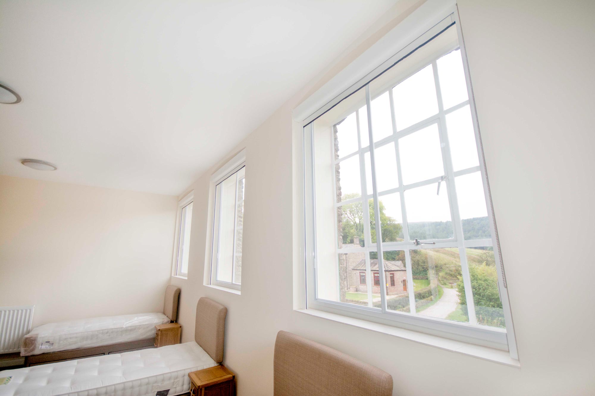 A white wall with secondary glazing windows.