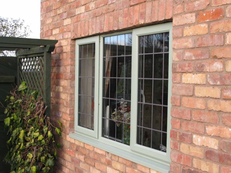 A brick house with uPVC timber alternative windows.